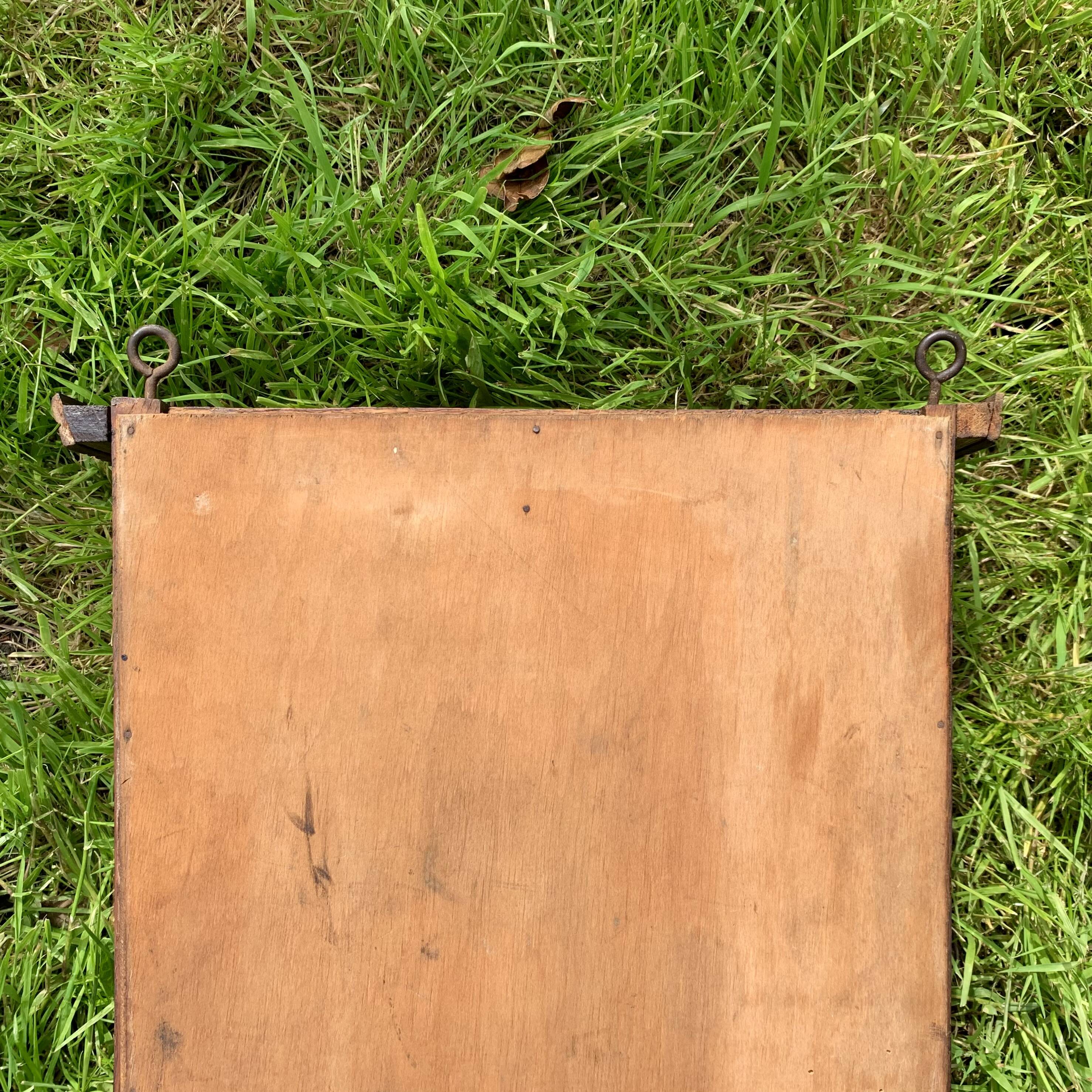 Old carved wooden medicine cabinet with beveled mirror