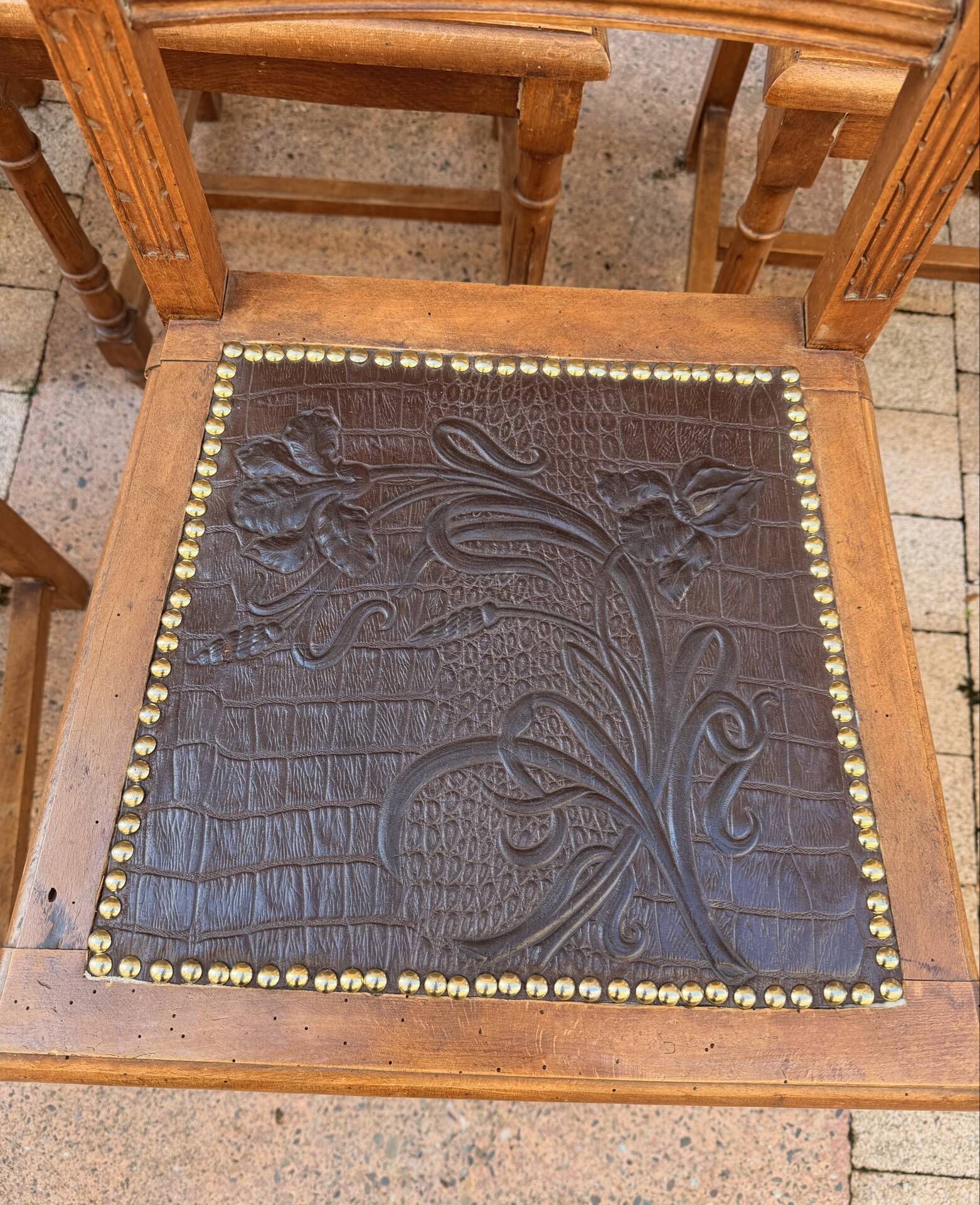 Set of 6 antique turned wooden chairs with embossed leather seats.