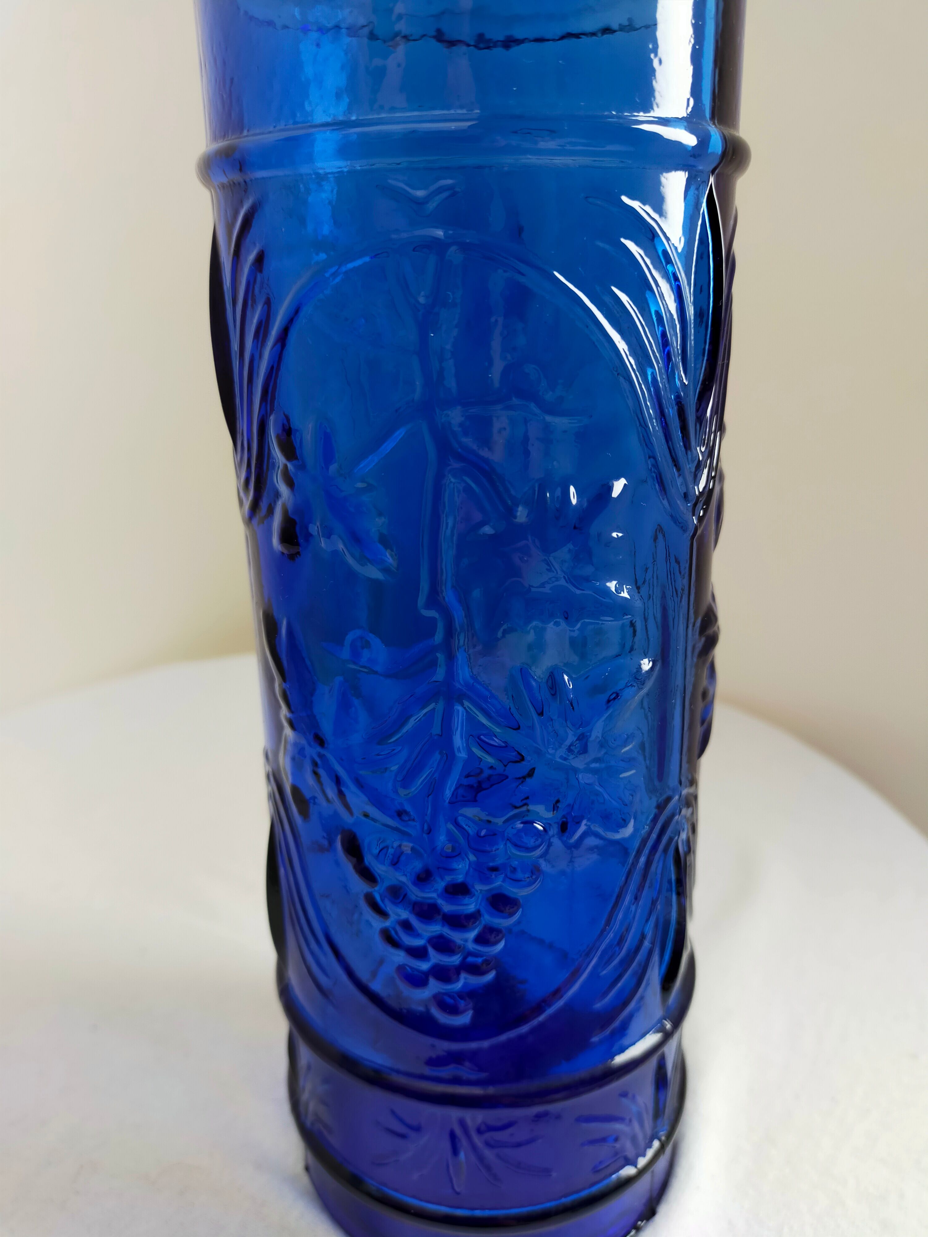 cobalt blue molded glass bottle in relief decoration bunches of grapes