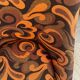 Vintage space age swivel chair with psychedelic pattern in shades of orange.