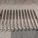 12 silver-plated metal table knives, Platil rocaille silversmith design, 24.6cm