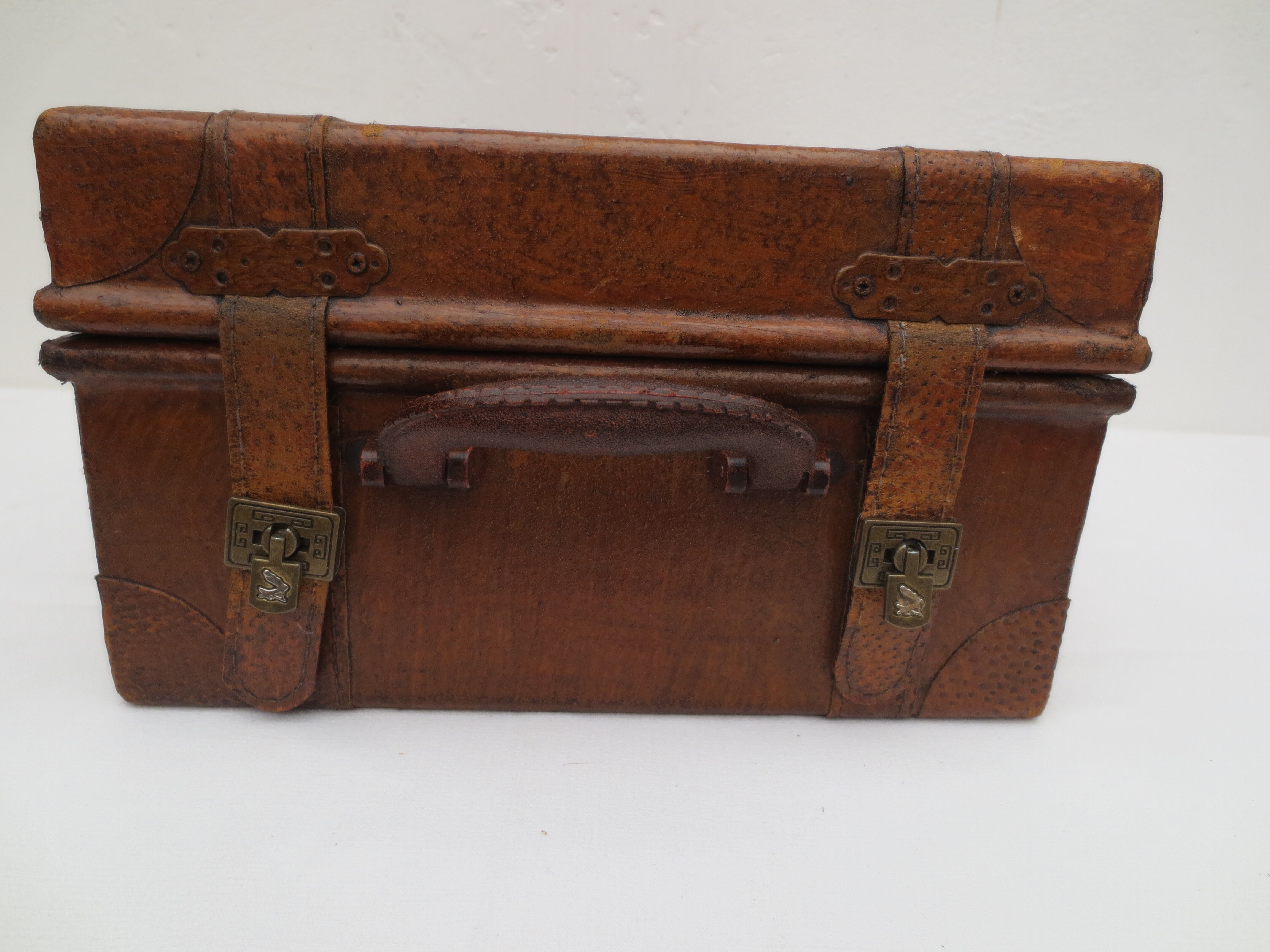 Rectangular wooden suitcase covered with leather