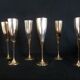 Lot of 12 silver metal flutes on brass stand