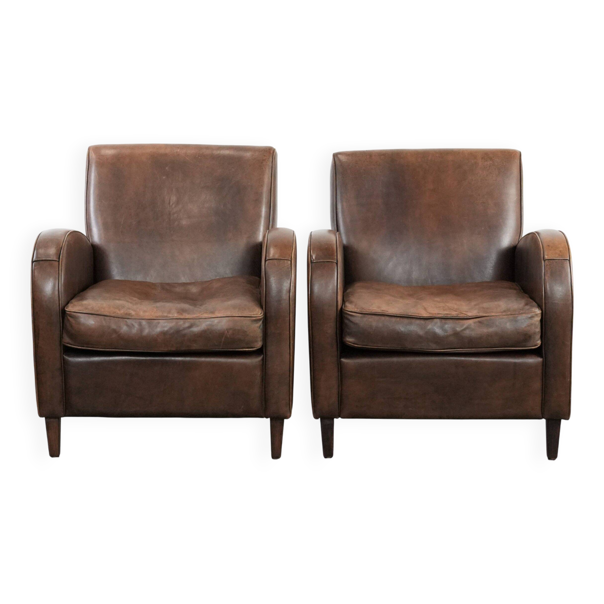 Elegant set of two sheepskin leather armchairs with beautiful round shapes