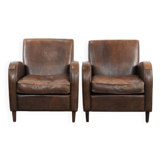Elegant set of two sheepskin leather armchairs with beautiful round shapes