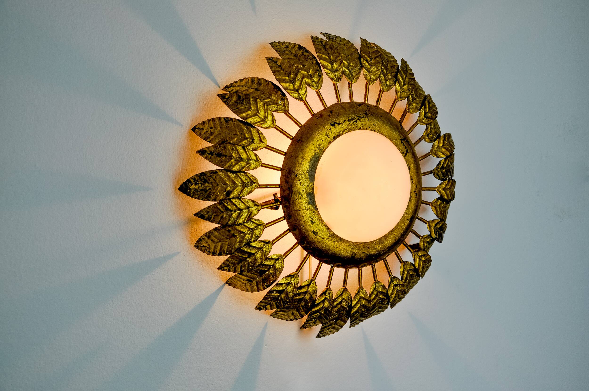 Sun wall lamp by ferro arte, metal and gold leaf and opaline glass, Spain, 1960