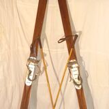 pair of vintage wooden Skis and their bats.
