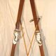 pair of vintage wooden Skis and their bats.
