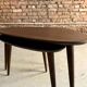 A pair of tripod and nesting coffee tables in walnut and midnight blue.