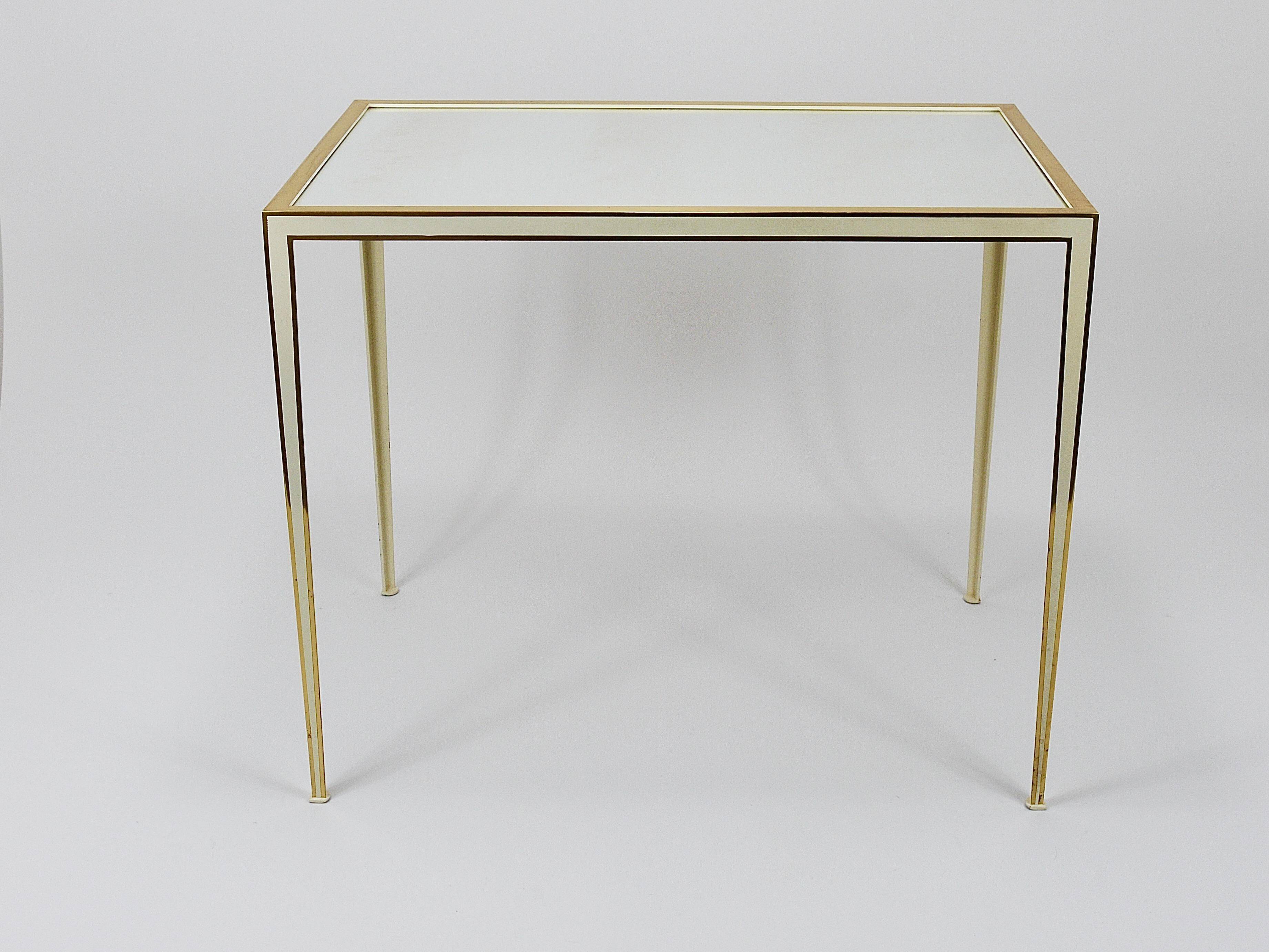 A pair of brass and white mirror tables from Vereinigte Werkstätten, Germany, 1970s.