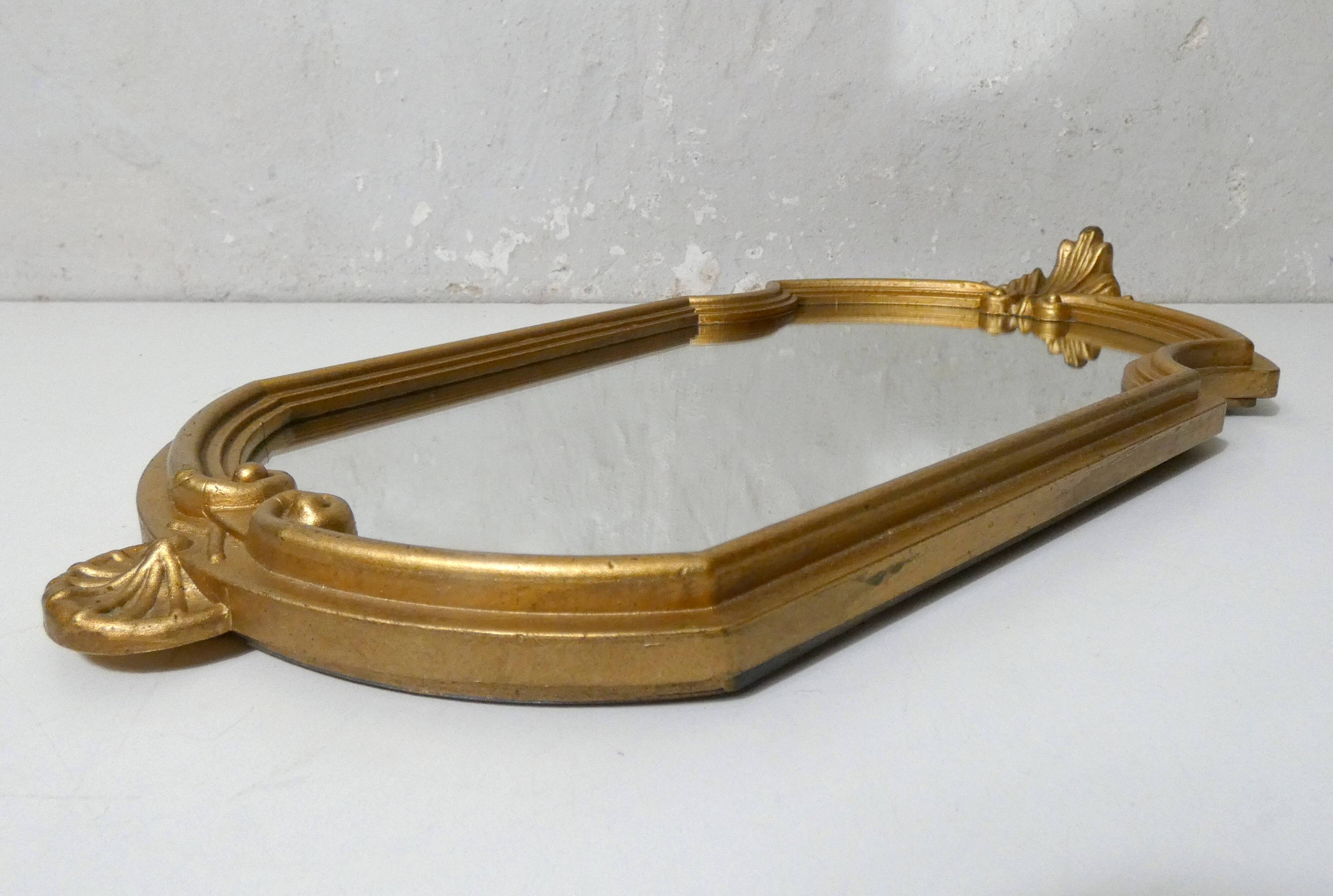 Antique Louis XV style mirror with a vintage carved gold frame.