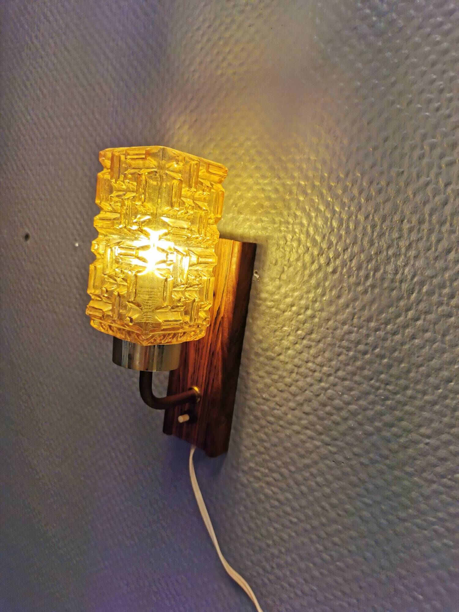 wall lights in rosewood look, with amber coloured glass and brass details.