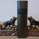 Small roaring lion bookends in patinated metal on a marble base.