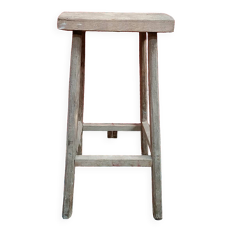 Vintage artisanal stool with rounded wooden seat