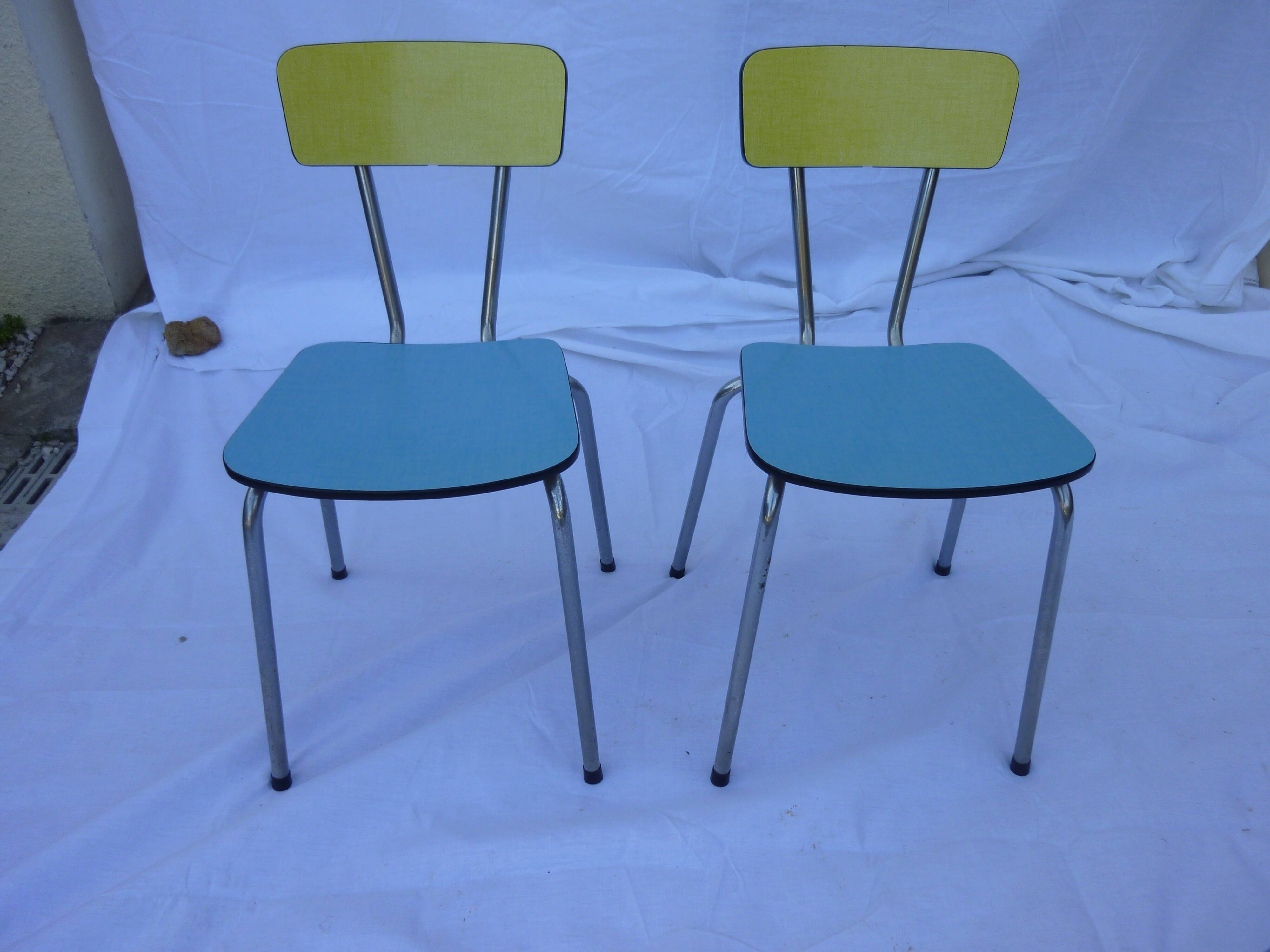 Two chairs and a yellow and blue stool in formica
