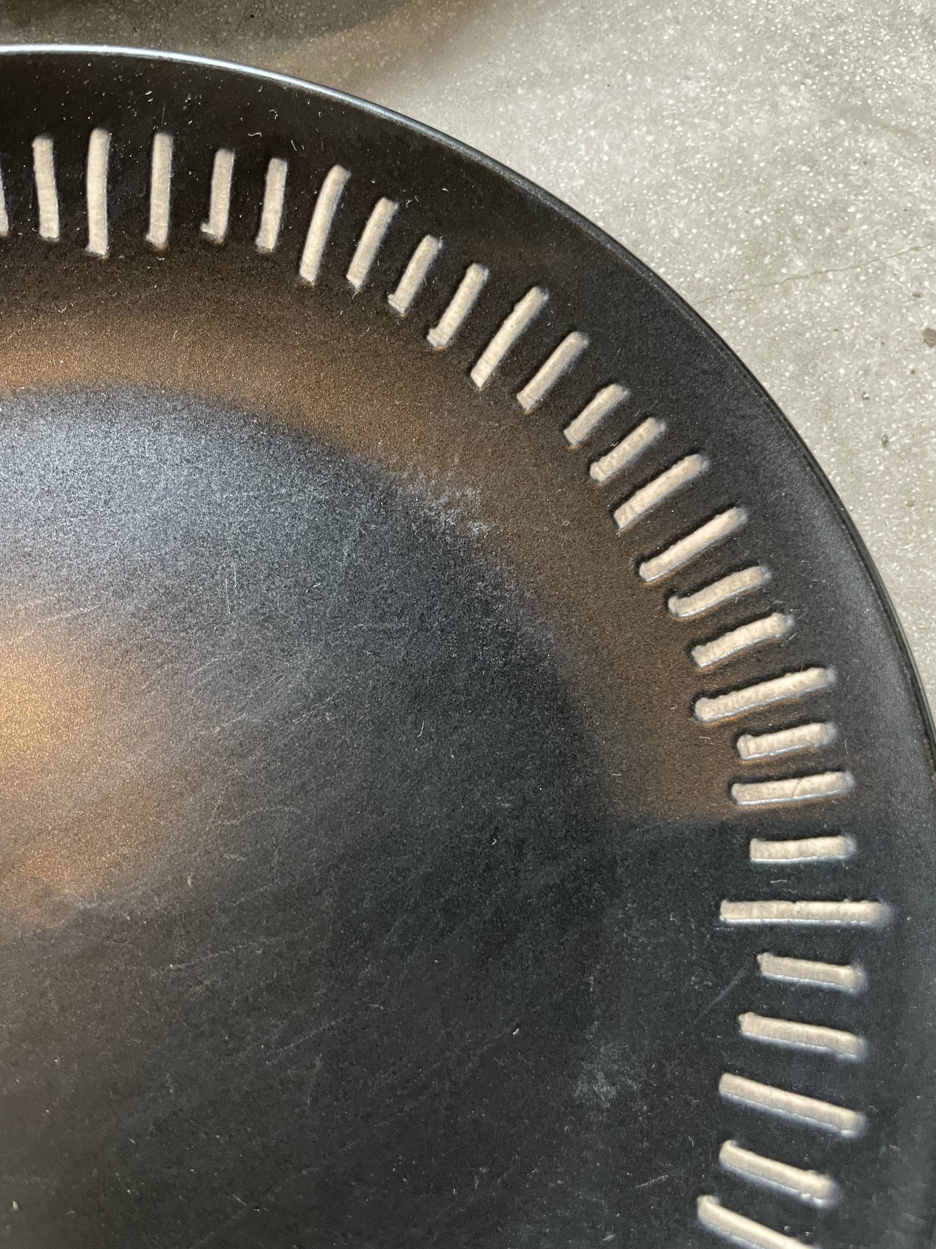 7 black ceramic plates