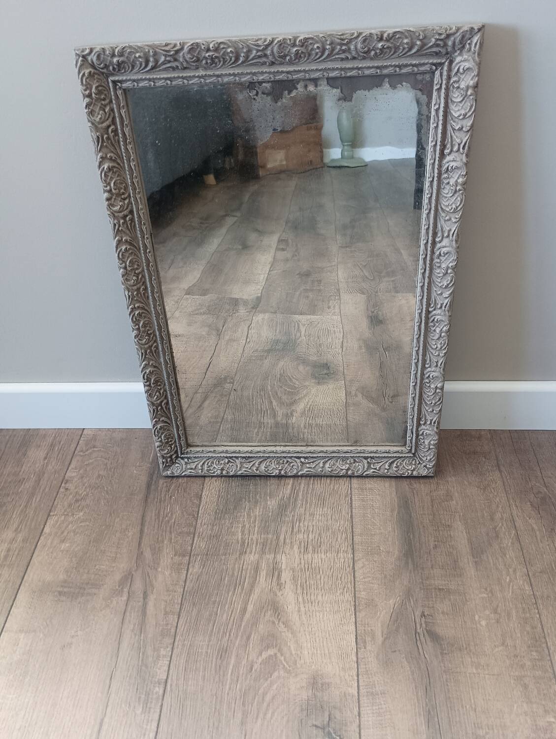Antique mirror in carved, painted and patinated wood