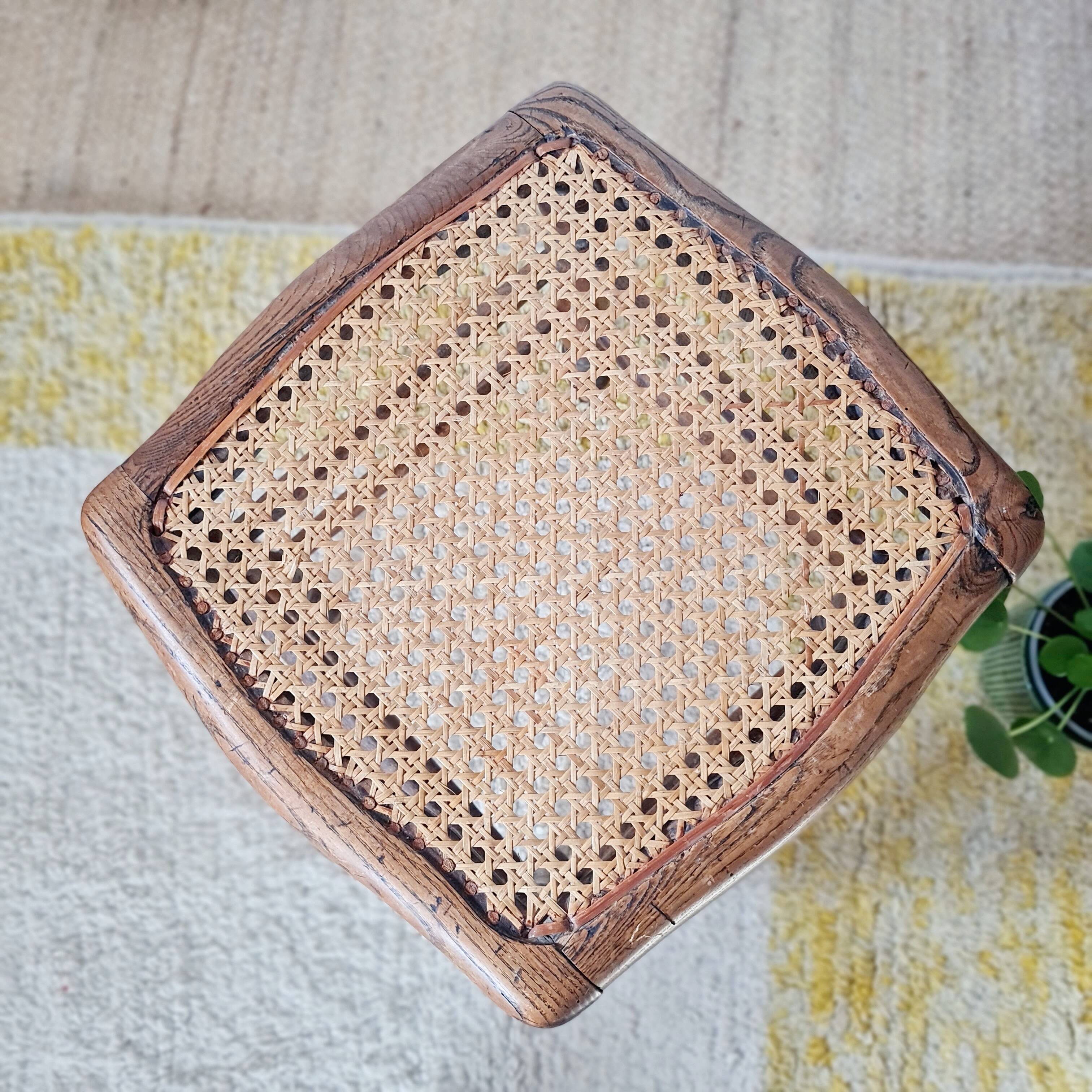 Wooden stool with cane seat