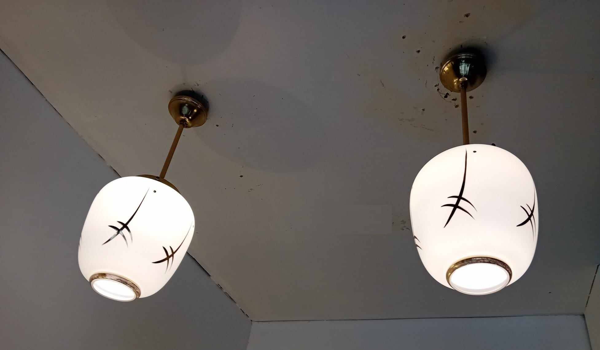 Pair of opaline globe pendant lights with stylized decoration, 1950s