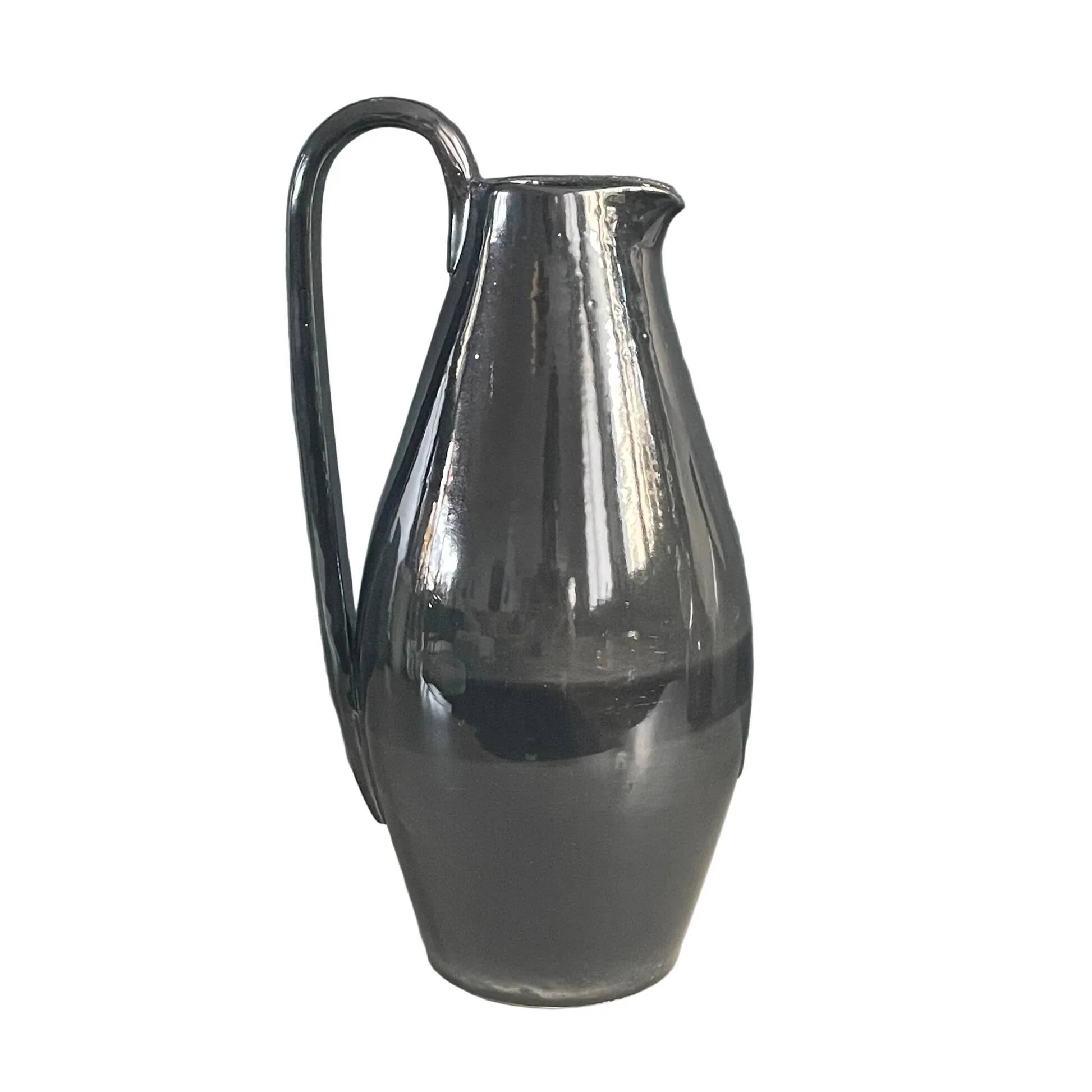 Black glazed ceramic pitcher signed M Azouit