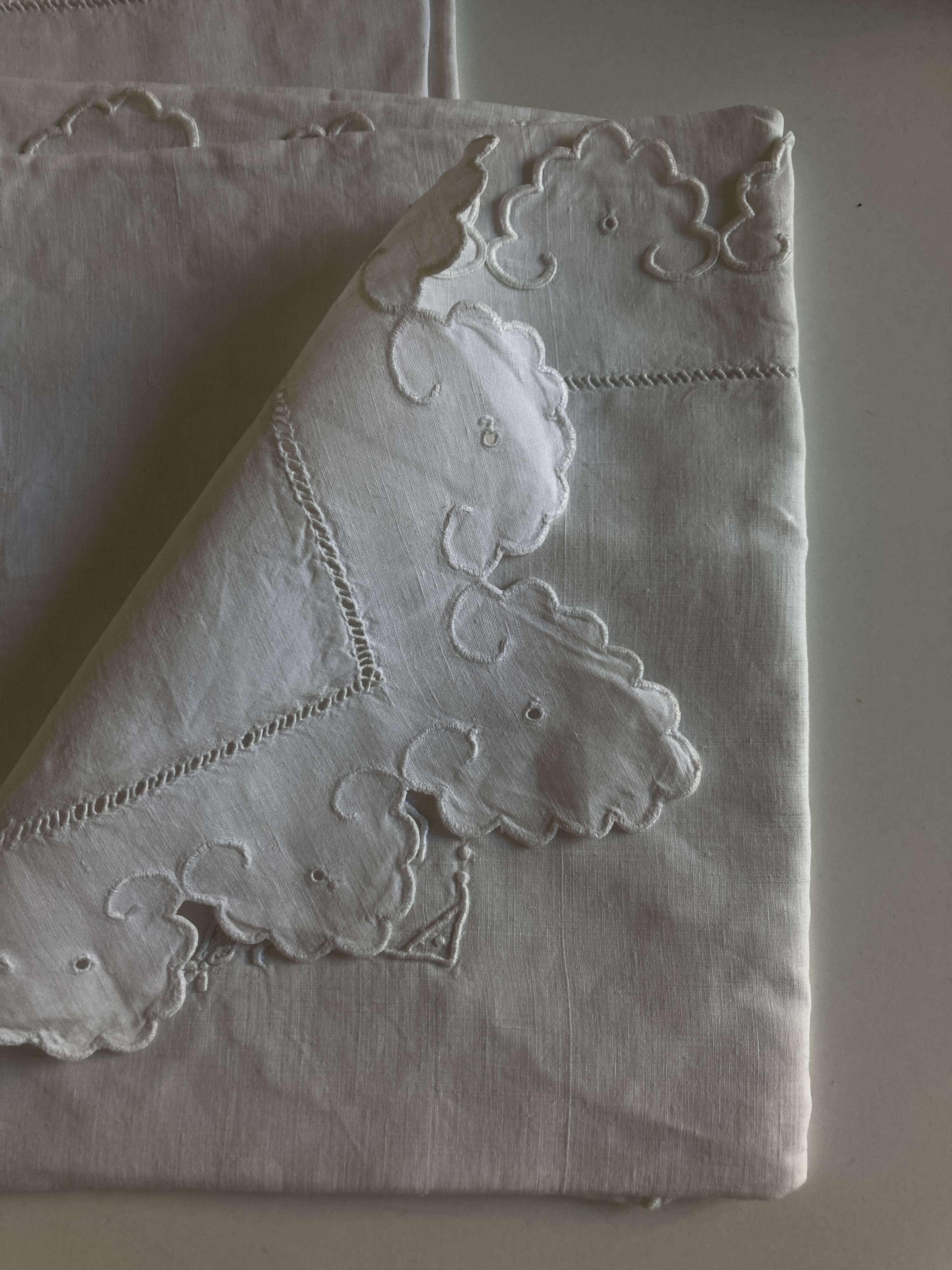 Pair of 19th century linen thread pillowcases embroidered with scallops