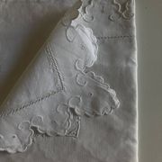 Pair of 19th-century linen pillowcases embroidered with scallops.