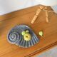 Shell-shaped ceramic catchall.