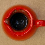 Orange earthen glazed pitcher