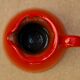 Orange earthen glazed pitcher