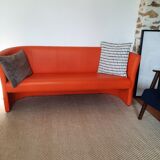 Curved vintage orange canapé with a pop spirit, seventies design piece.