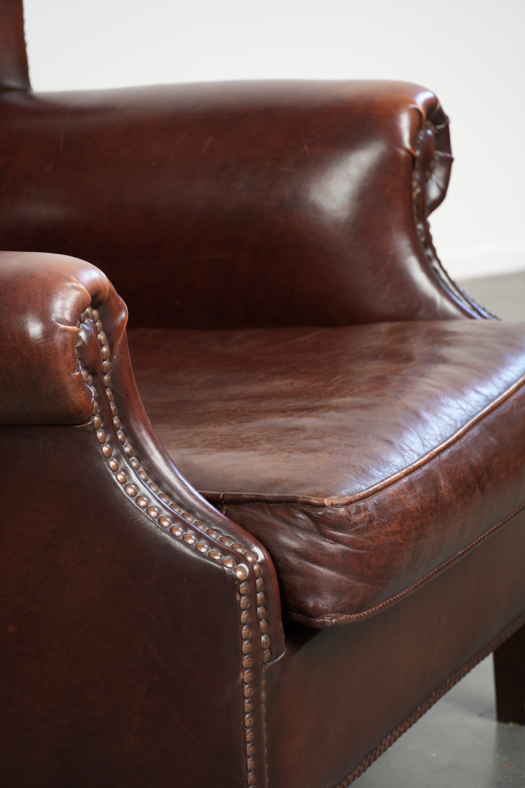Vintage sheepskin wingback armchair with a timeless English look