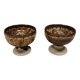 A set of ceramic candle holders in earthy colours.
