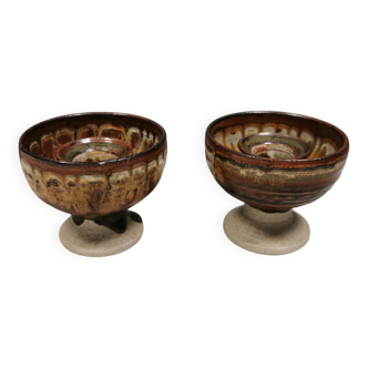 A set of ceramic candle holders in earthy colours.