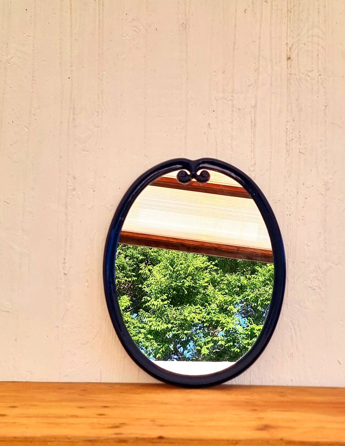 Vintage enameled blue oval mirror