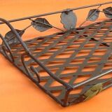 Rectangular metal serving tray with floral decoration.