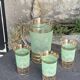 Serve an orangeade, a carafe and 3 glasses in green granite with golden trim.