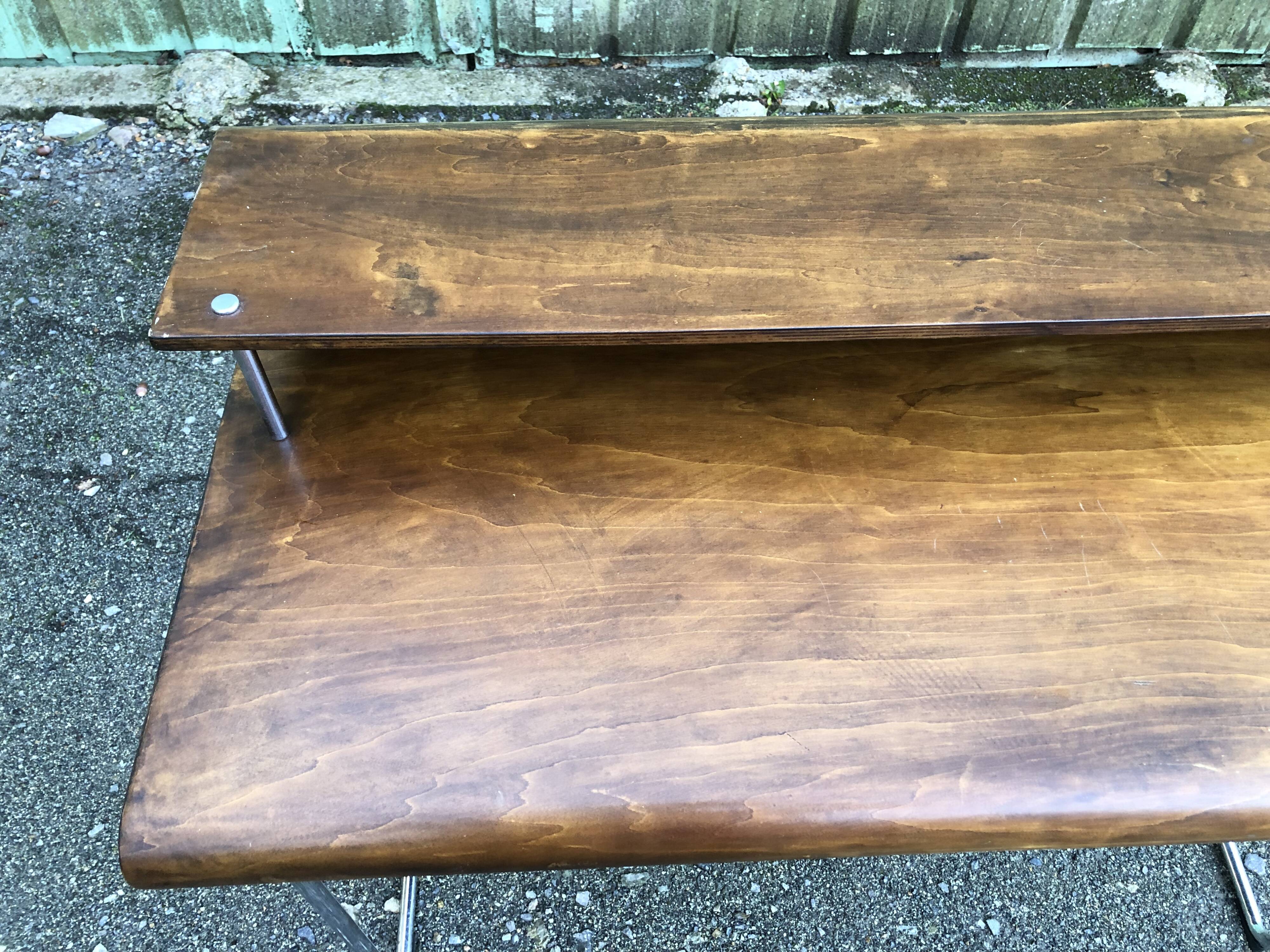 Design desk in formed glued laminated wood with chrome tubular base.
