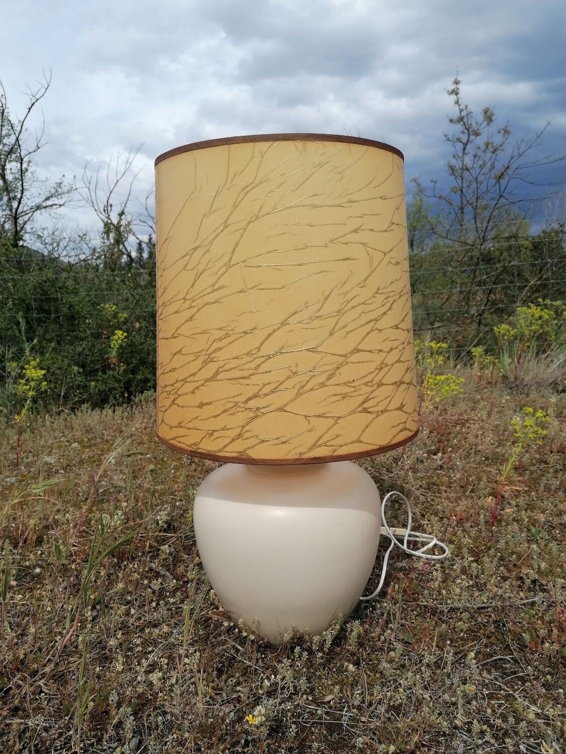 Vintage ceramic table lamp and golden lampshade.