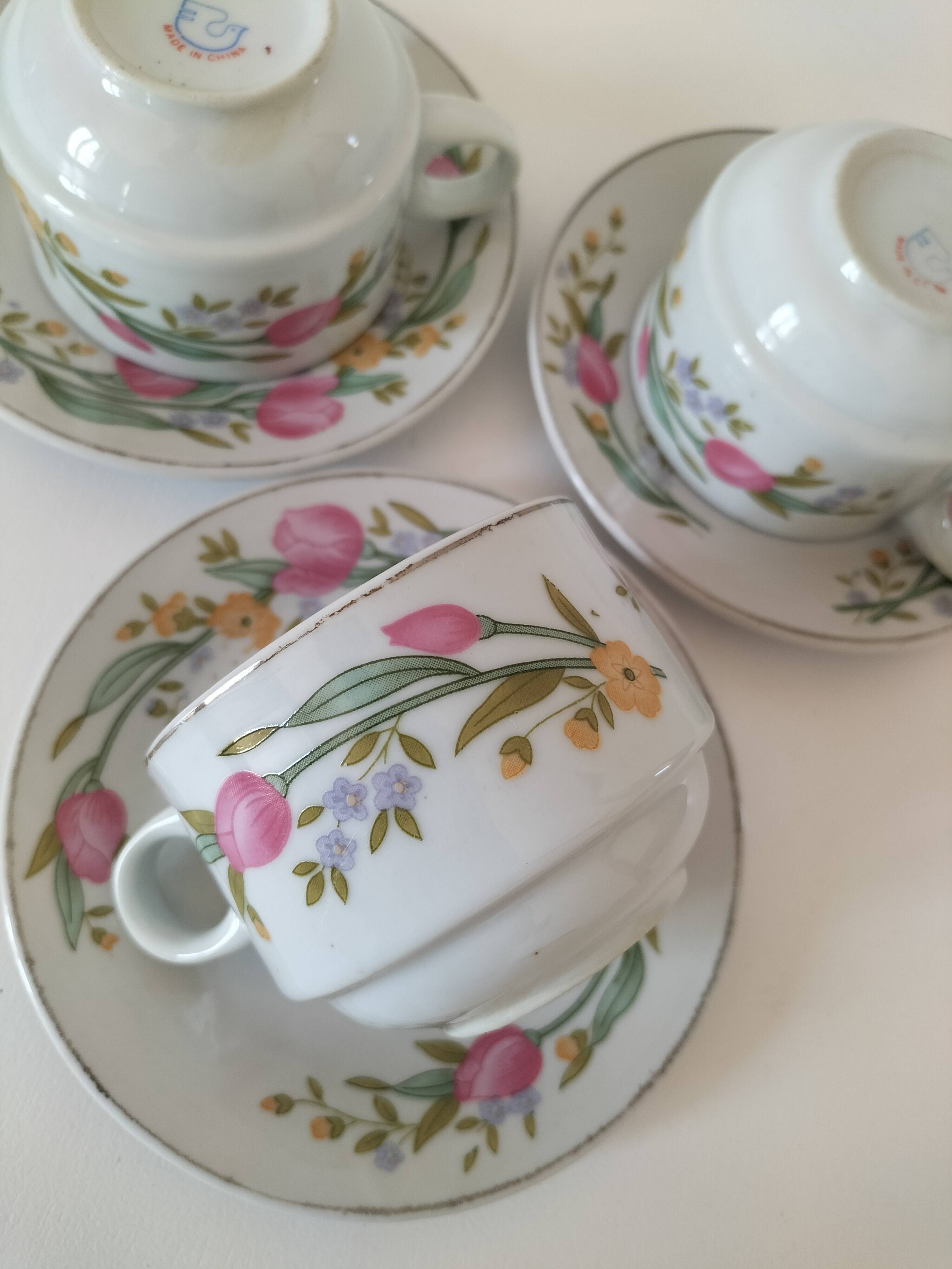 Trio of floral porcelain cups and saucers
