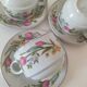 Trio of floral porcelain cups and saucers