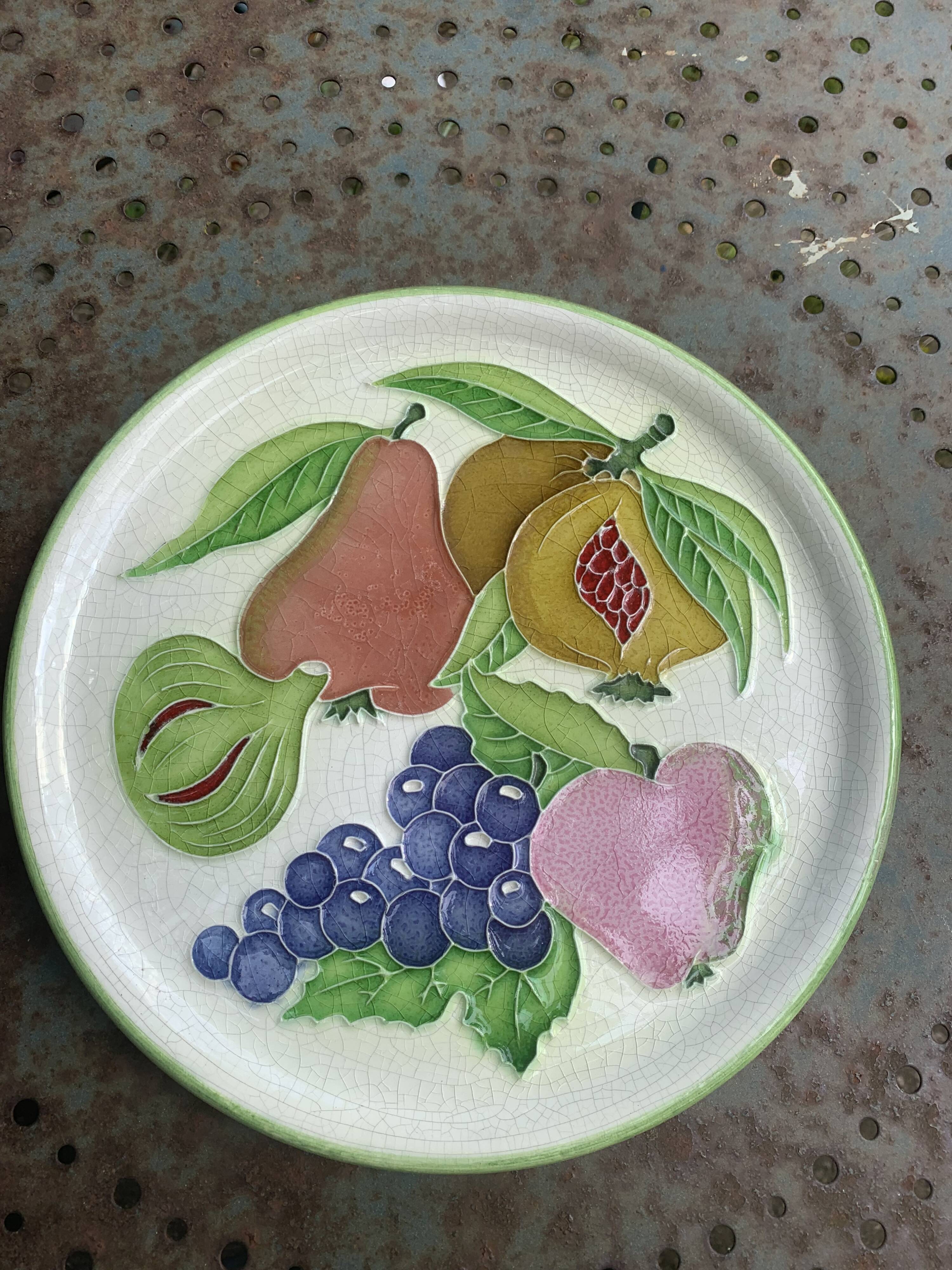 Decorative plate to hang, fruit model, in enamelled ceramic, Les Fruits, signed Luciano