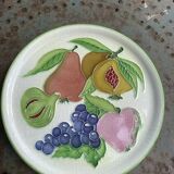 Decorative plate to hang, fruit model, in enamelled ceramic, Les Fruits, signed Luciano