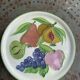 Decorative plate to hang, fruit model, in enamelled ceramic, Les Fruits, signed Luciano