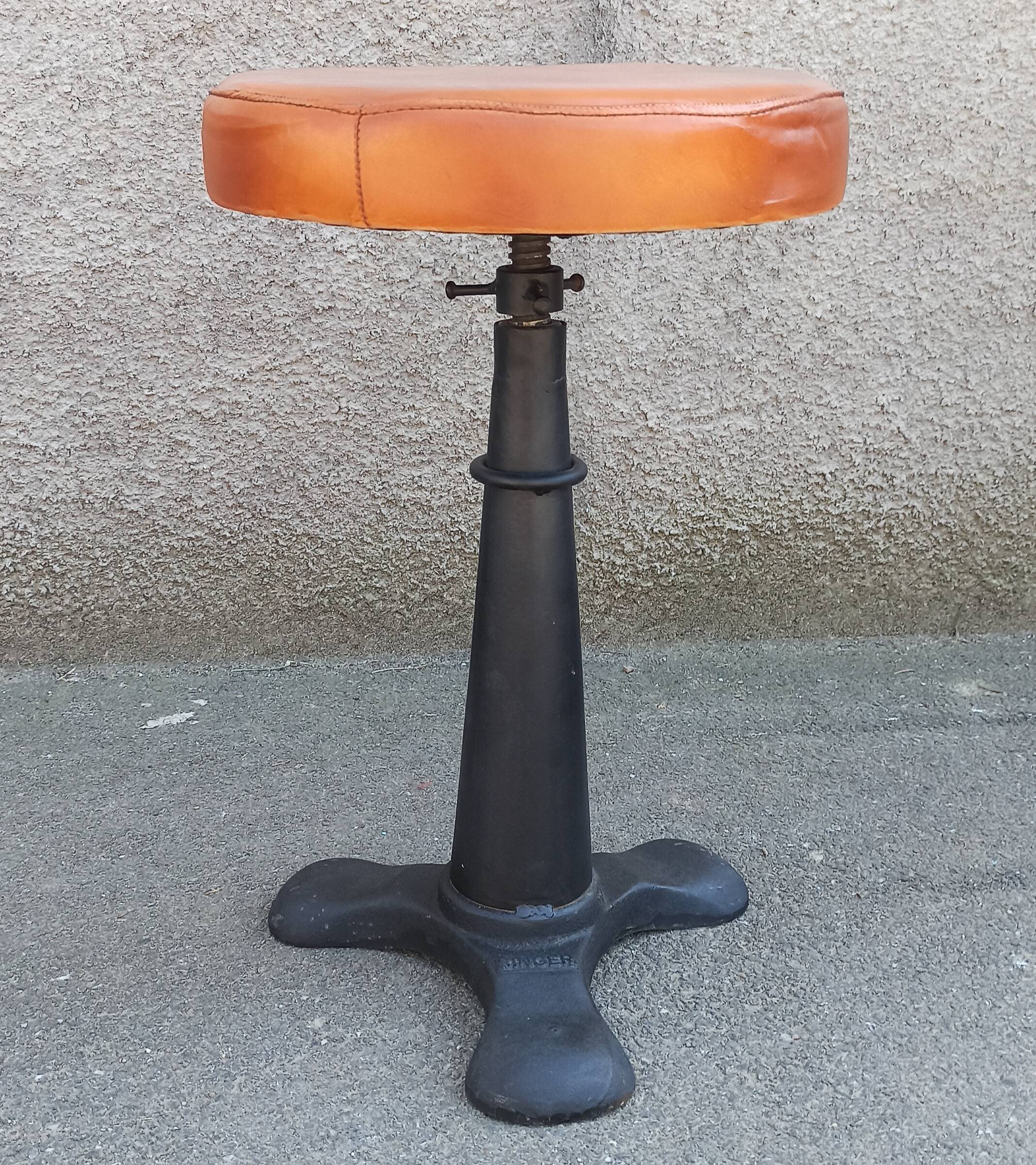 Height-adjustable leather stool with cast iron base