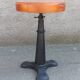Height-adjustable leather stool with cast iron base