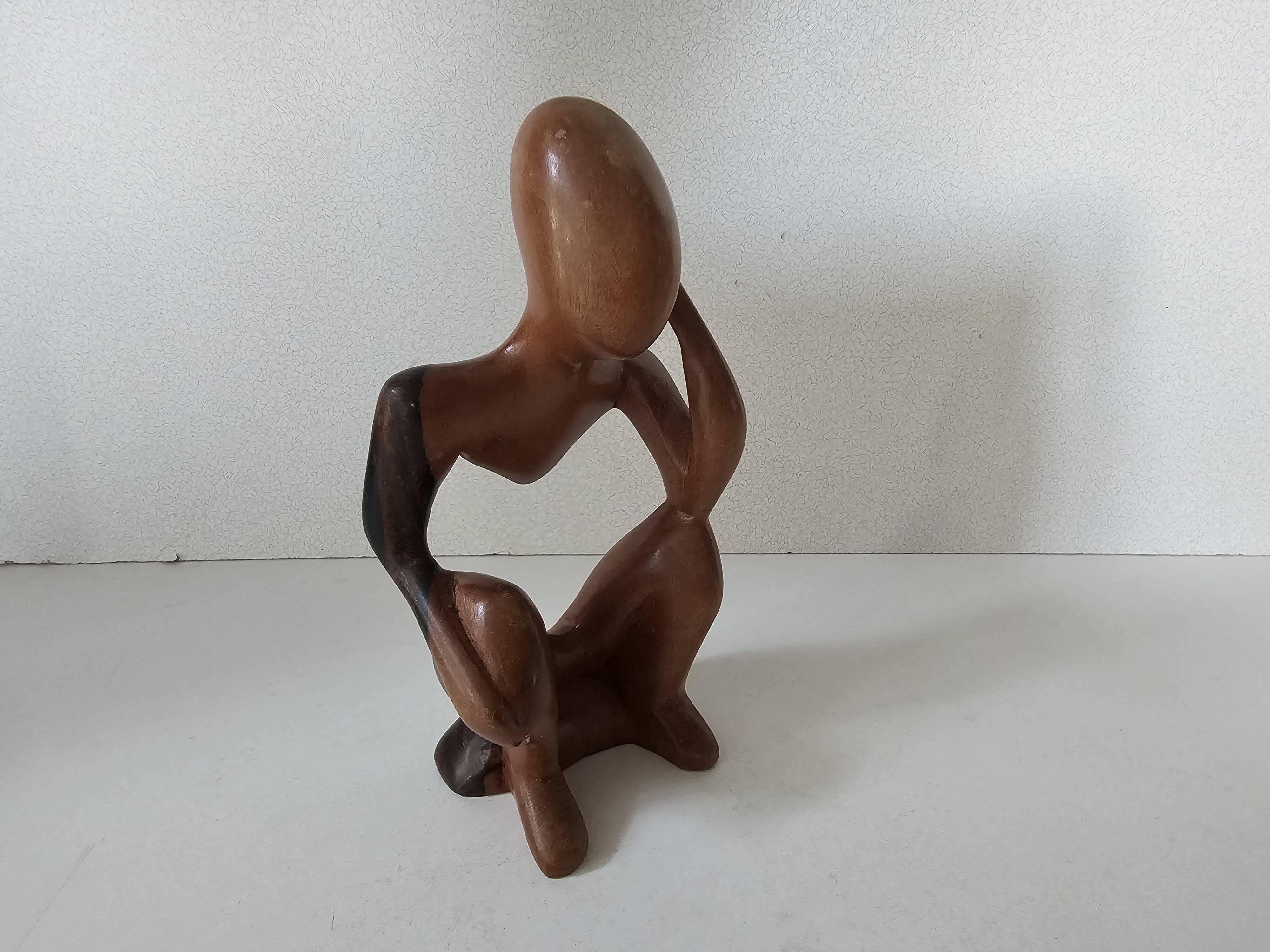 Wooden statuette sculpture of a thinking man design