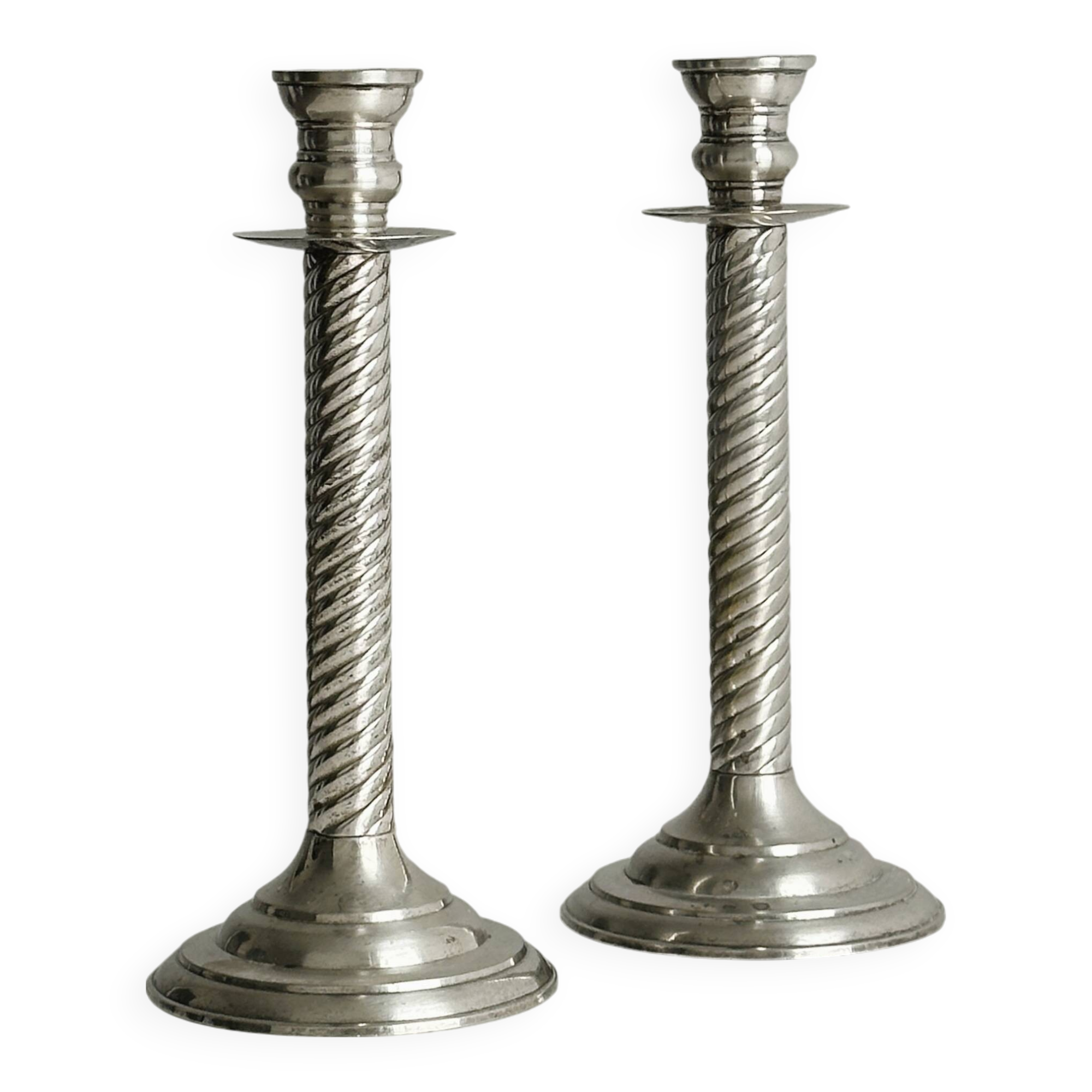 Patinated silver-plated metal candlesticks