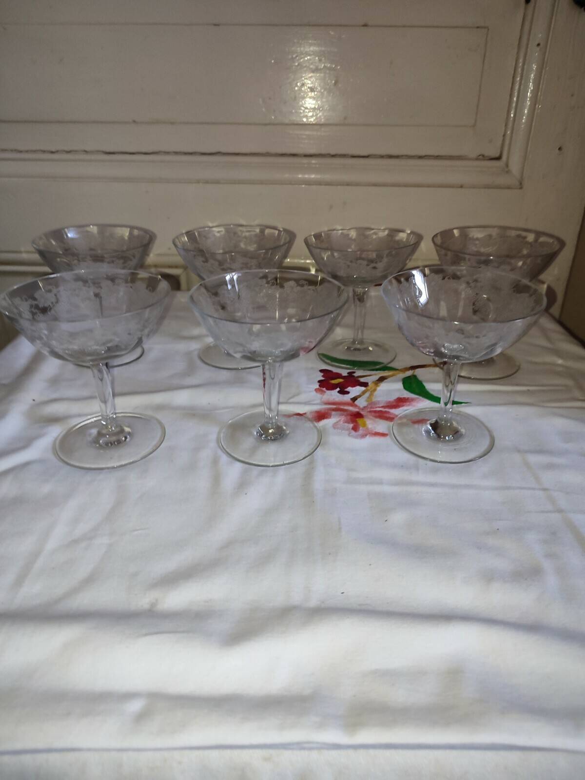 Beautiful set of seven crystal champagne glasses engraved with vine branches