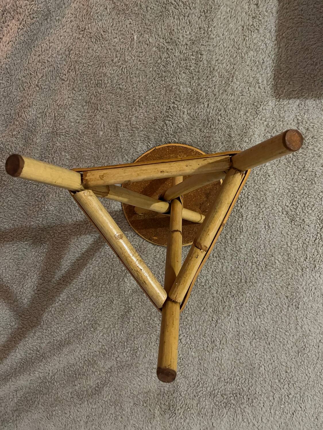 Plant holder or side table at the end of a bamboo sofa