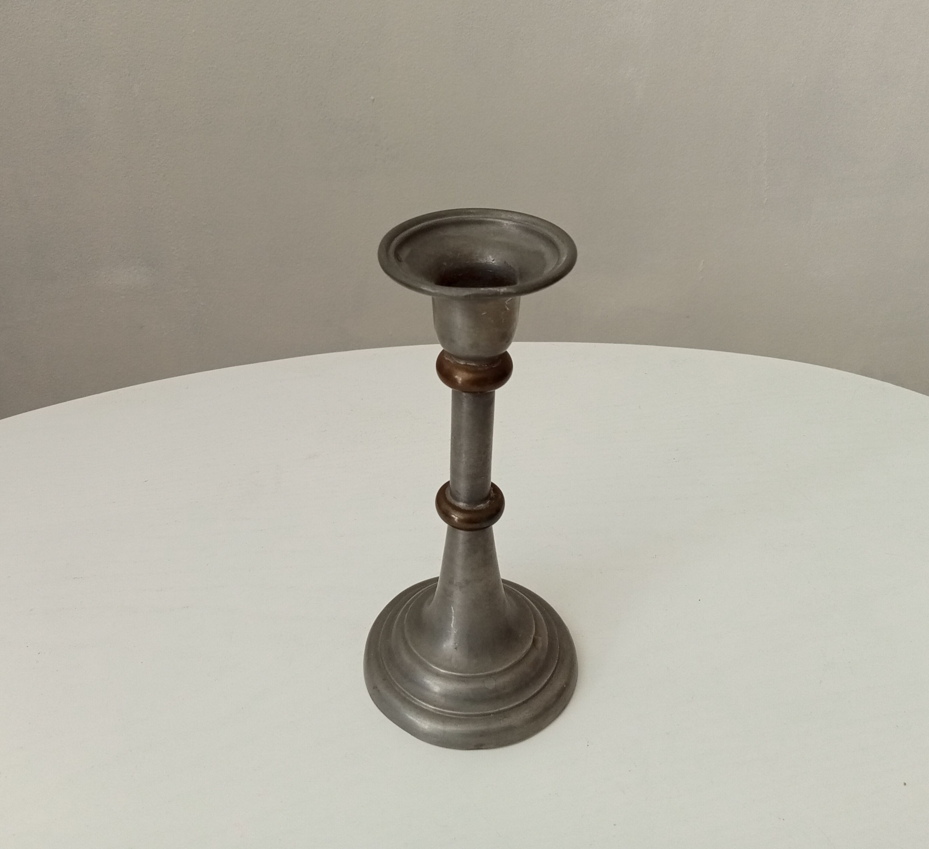 Antique candle holder in pewter and brass